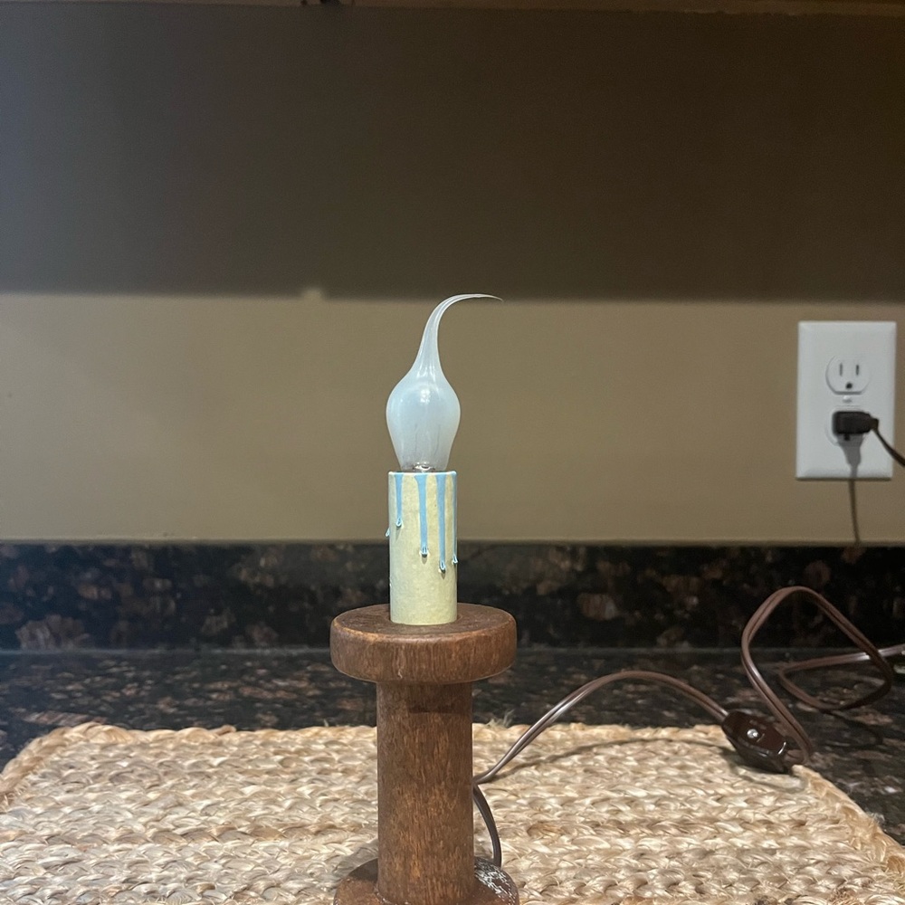 Antique bobbin electric candle lamp.